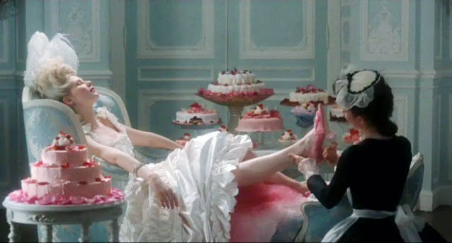 Screenshot of the movie Marie Antoinette featuring Kirsten Dunst with pastries
