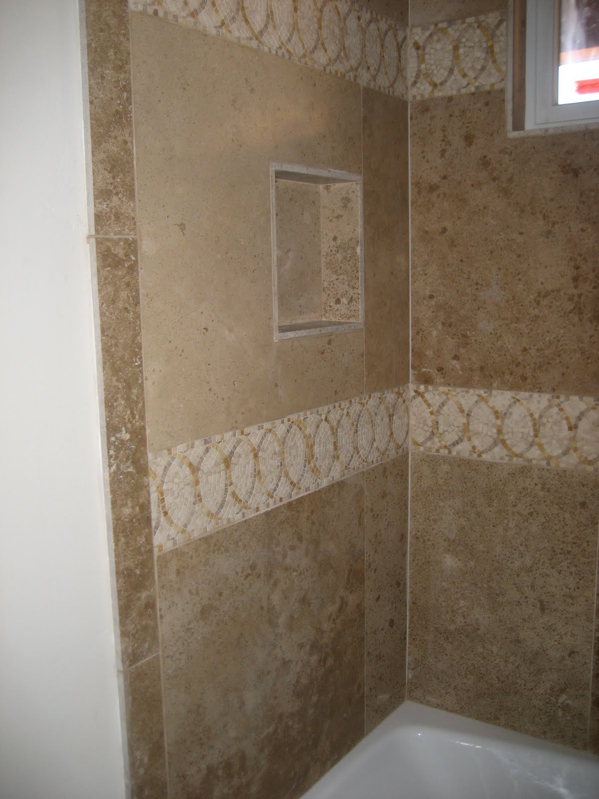 custom bathroom shower 24x24 travertine stone with decorative strips around tub with tile 