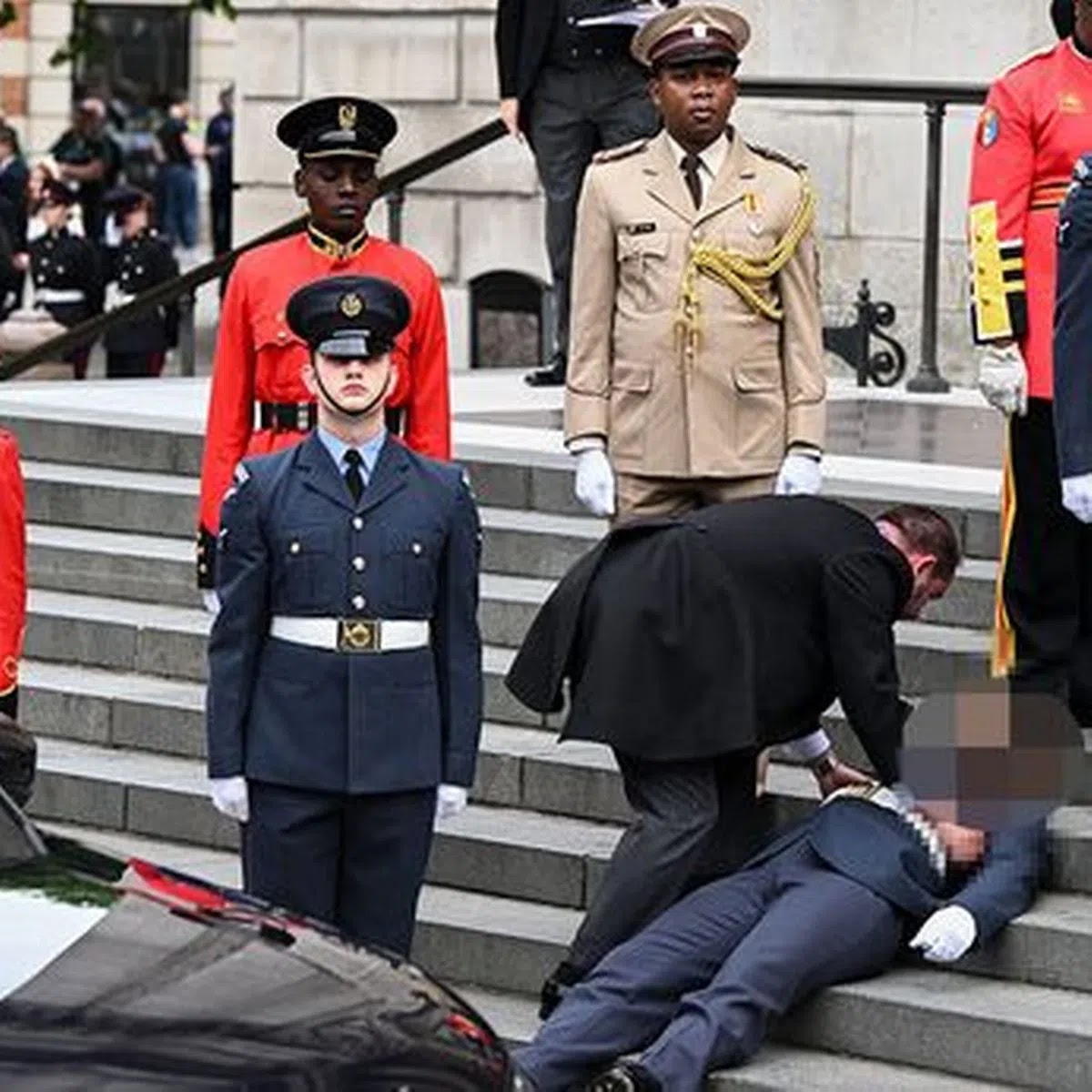 A military personnel faints on the steps outside St Paul’s Cathedral for the Thanksgiving service in honour of the Queen
