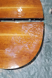 A photograph of part of a wooden table with a botched resin job that had to be sanded down. The mistakes are evident.