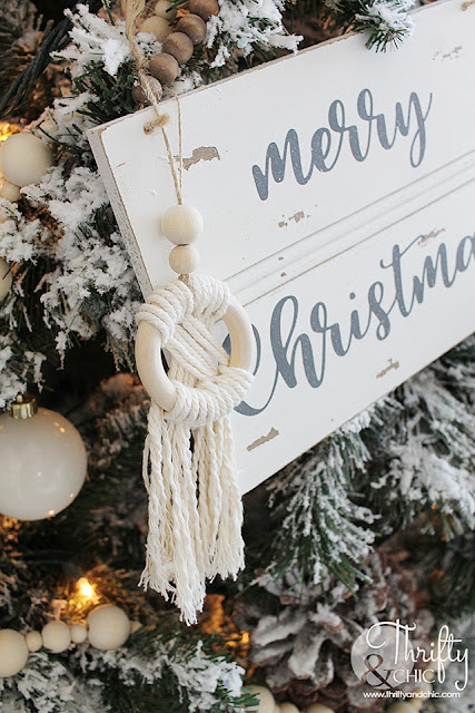 Neutral Christmas living room decor. Wood and white Christmas decor. Boho style Christmas decor. Bohemian style Christmas tree. Beaded and macrame Christmas tree decor and decorating ideas. How to decorate a Christmas tree. Farmhouse style Christmas decor. Wood and White Christmas mantel decor. Vintage Christmas mantel ideas. Flocked Christmas trees. Two story living room design.