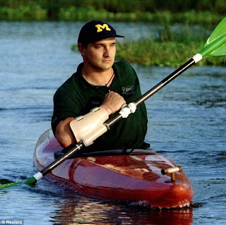 Paul Templer using a specially adapted kayak paddle two years after he was attacked and almost killed by an angry bull hippopotamus