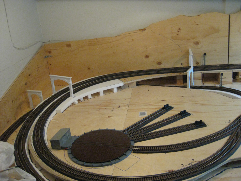 Two single and two double styrene tunnel portals placed on model railroad track to test fit
