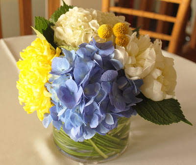 dark blue hydrangea white peonies and yellow billy buttons