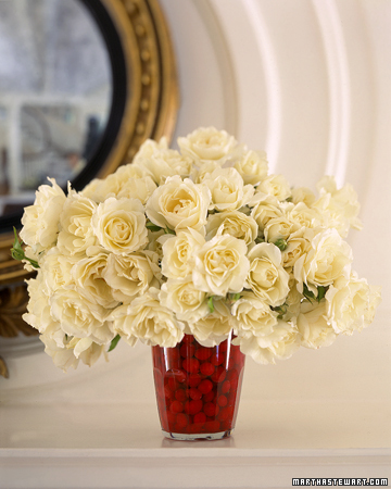 This centerpiece uses a white pumpkin as a vase I love the