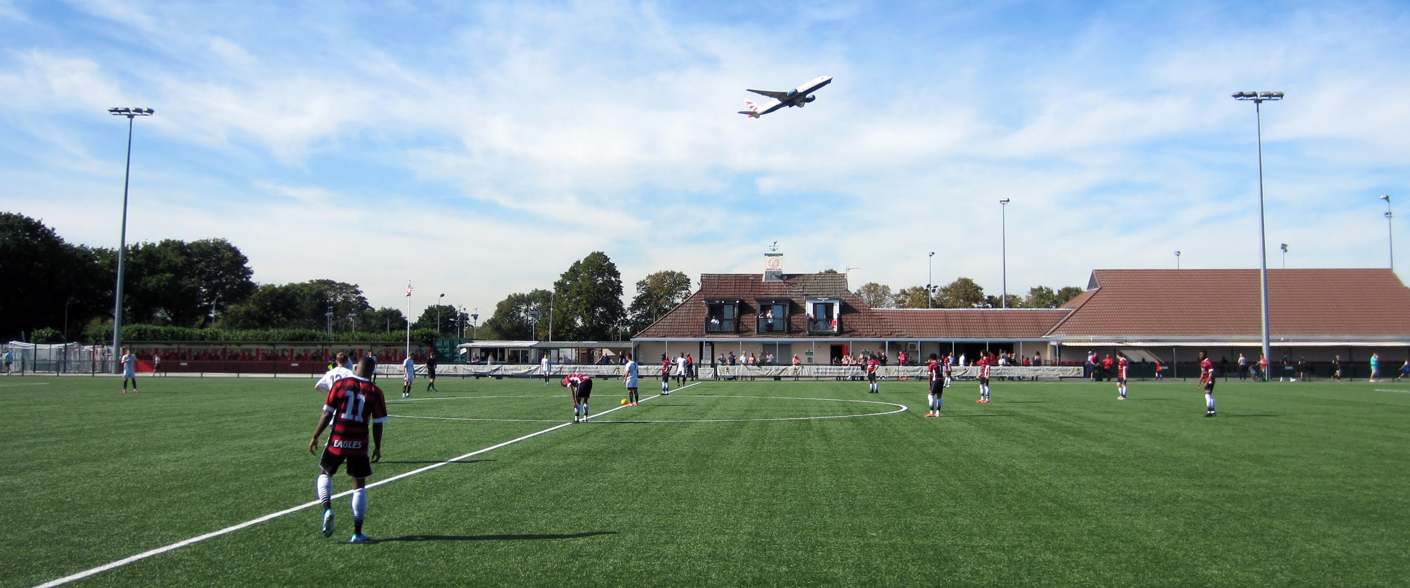 A plane takes off above Bedfont Sports Recreation Ground