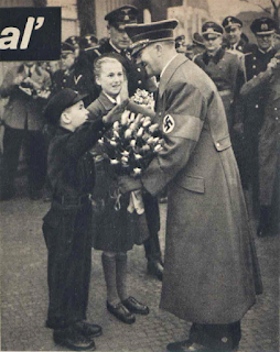 Hitler being given flowers by members of the Hitler Youth