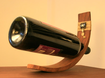 Good Glass makes wooden wine bottle holders decorated with wire and beads