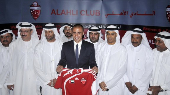 Fabio Cannavaro poses with his new jersey for Al-Ahli club during a news conference