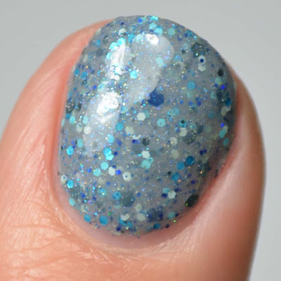 grey nail polish with glitter close up swatch