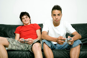 Boys playing video game console