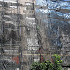 Trash Bag Camouflage - Shiny black veil, tarps and scaffolding on Berry in Williamsburg.