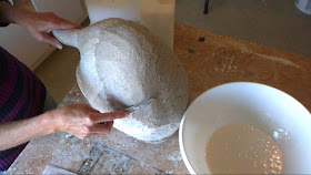 adding paper clay to the swan armature covered in paper mache
