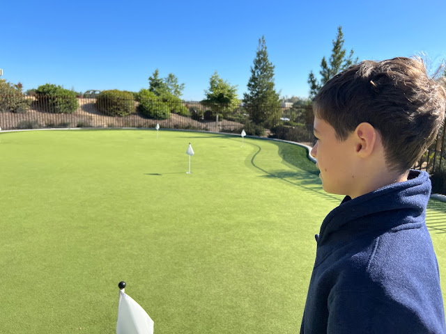 Little boy golfing