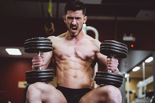 A bodybuilder lifts high weight
