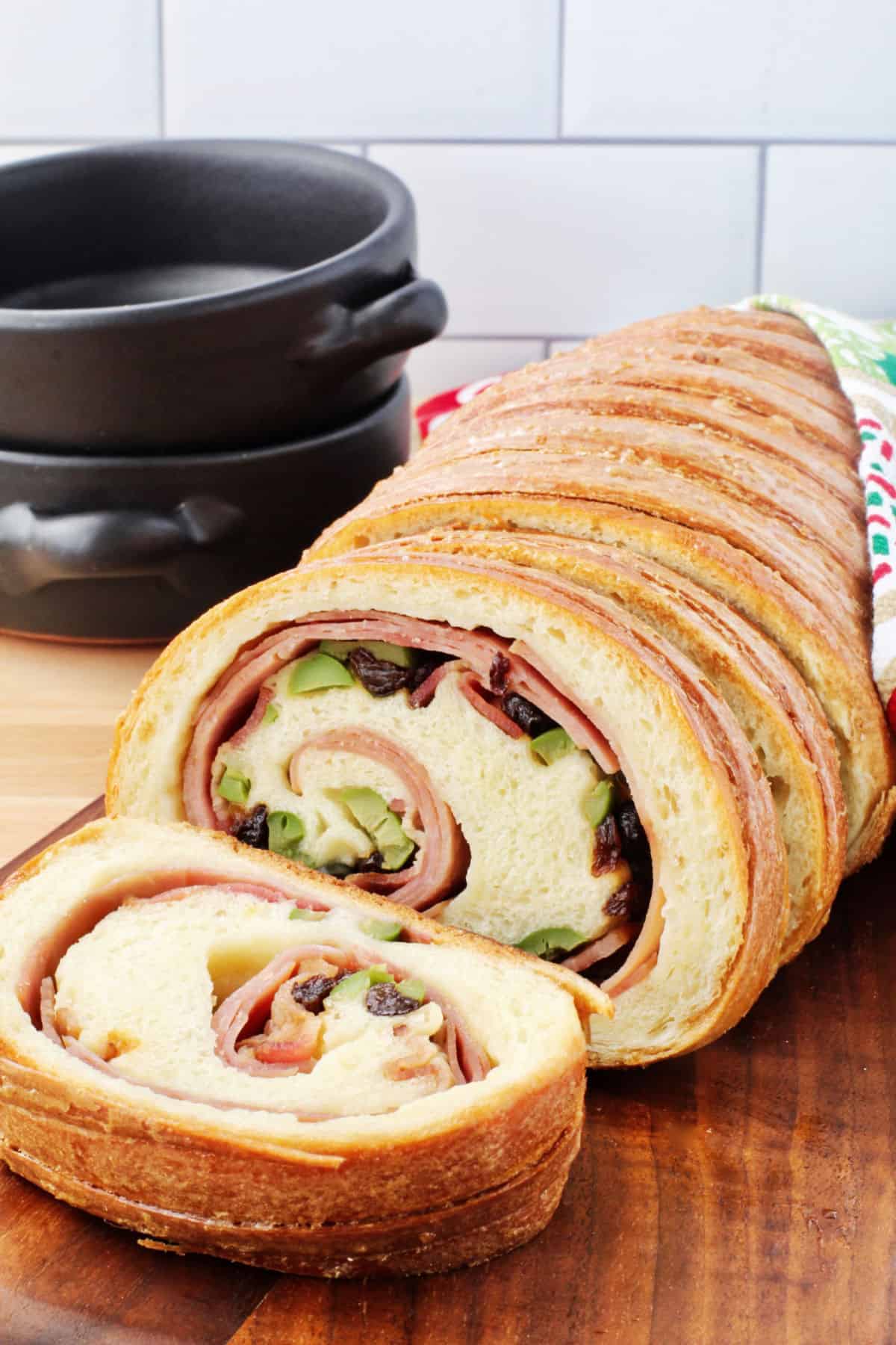 Pan de jamon on a cutting board, sliced.