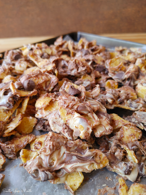 Peanut Butter Chocolate Frito Munch! A quick 4-ingredient sweet and salty recipe of Fritos corn chips and chocolate morsels covered in white chocolate and peanut butter then cooled into a candy bark.