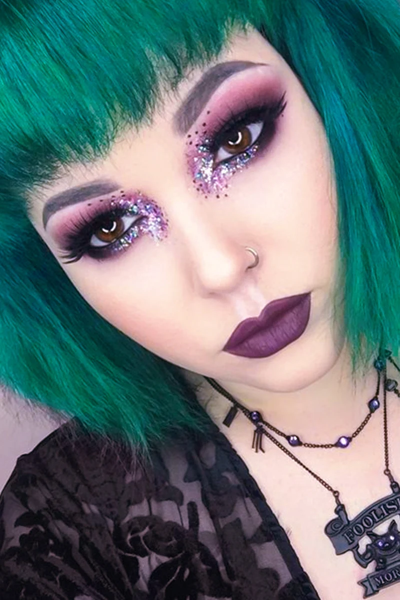 close-up portrait of a beautiful young woman with a pretty goth makeup look