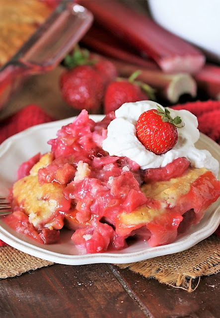 Plate of Strawberry Rhubarb Cobbler with Whipped Cream Image
