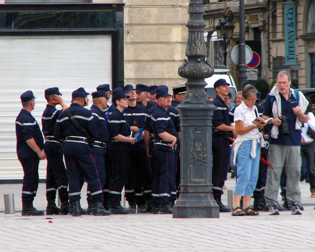 Tourists and police officers in place Vendôme, Paris