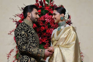 Deepika Padukone pose for photographers during their wedding reception held at the Leela Palace in Bangalore