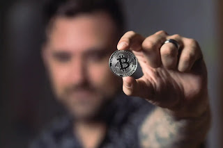 man-holding-bitcoin-in-hand