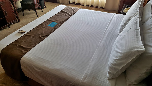 king bed at the suite room of Waterfront Mactan Airport Hotel & Casino