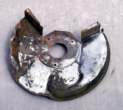 Image of an Opel Manta brake disc back plate on a grey background