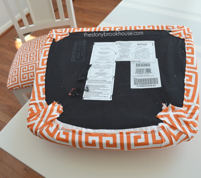 Chair cushion covered with fabric and staple gun