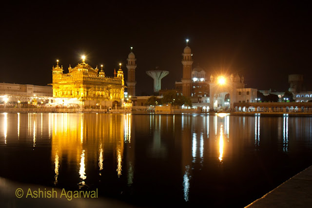 View of the Golden Temple in Amitsar from an angle, along with a view of minarets in the back