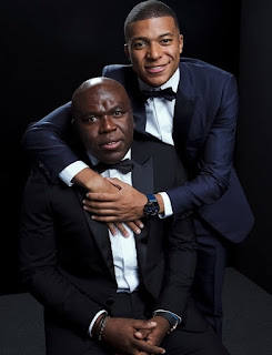 Wilfried Mbappe posing for picture with his son Kylian Mbappe