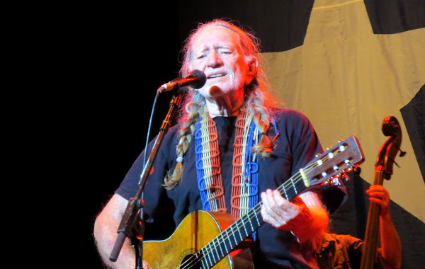 Willie Nelson plays guitar