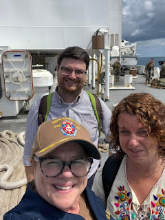 USU certified women's health practitioner Navy Capt. Carolyn Currie, USU preventative medicine and biostatistics associate professor Dr. Lynn Lawry, and Joshua Kumpf, curriculum manager for USU's Center for Global Health Engagement aboard the USNS  Comfort for Continuing Promise 2022. (Photo credit: Navy Capt. Carolyn Currie)