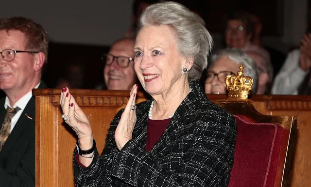 Princess Benedikte wore a black and gray tweet jacket and a burgundy midi dress. Pearl necklace and diamond earrings