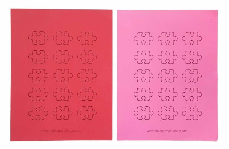 puzzle pieces printed on red and pink cardstock.