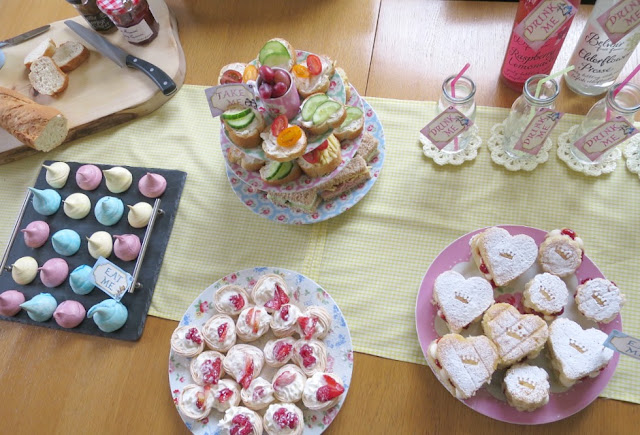 Home made birthday afternoon tea food and drink on Cath Kidston plates perfect for Spring mini meringues in different colours 