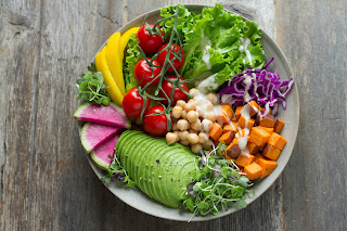 a salad with sweet potato, avocado, chickpeas, and cabbage