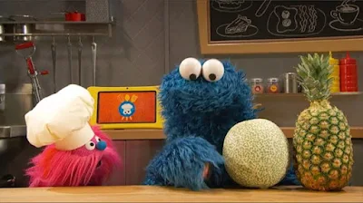 Sesame Street Episode 4808. Cookie Monster's Foodie Truck. A girl orders fruit salad from Cookie Monster and Gonger.