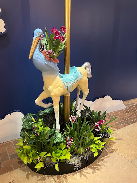 Mystical carousel characters full of orchids inspire the imagination.