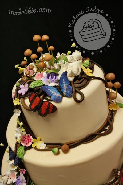 woodsy wedding cake mushroooms acorns butterflies vines