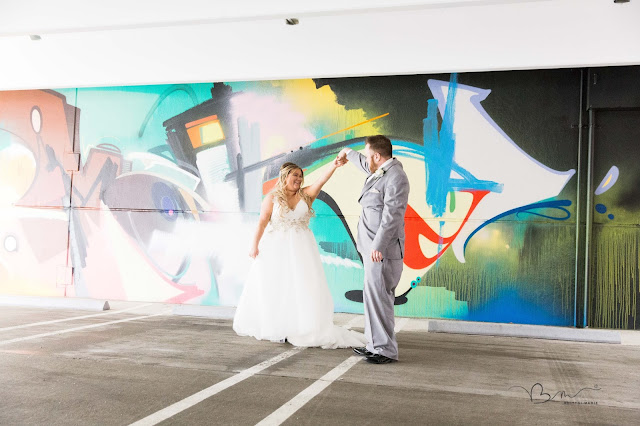 bride and groom dancing on the z belt lot in Detroit by graffiti