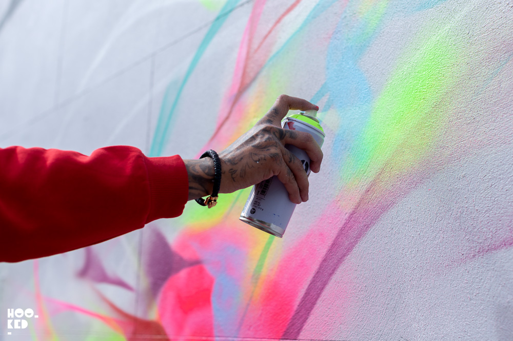 Brazilian street artists L7M at work on his mural in Cheltenham