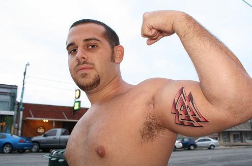 Note the tattoo of an eye inside a triangle tattooed on his forehead here.