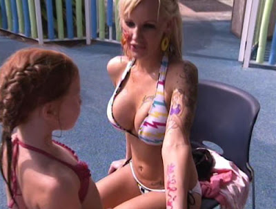 A little girl painting over Ashley's tattoo of herself n**ed and holding a 