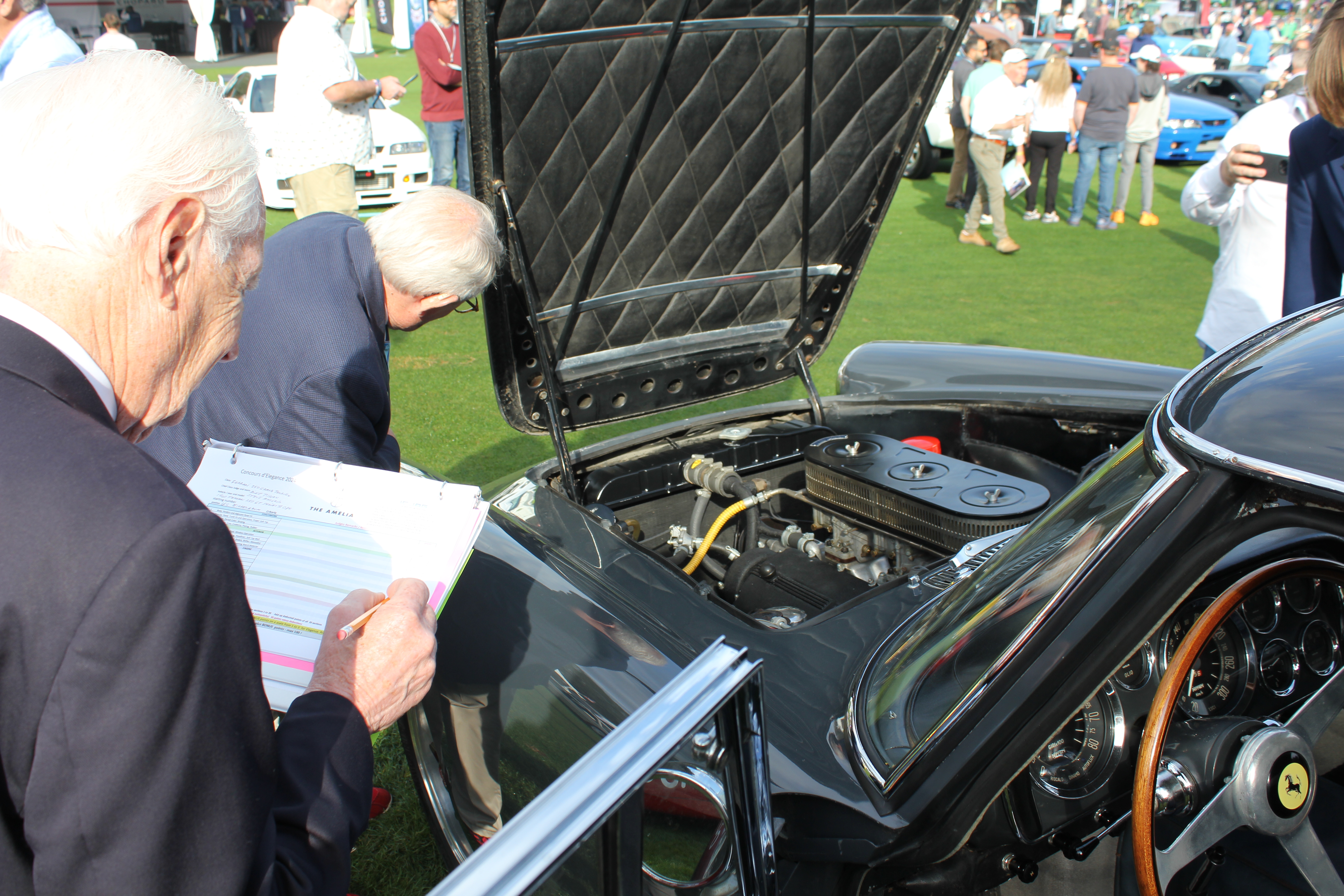 A judge carefully tallies points as he assesses the engine bay of this 1960 Ferrari 250 GT (Grand Touring). Being ‘unrestored’ makes this very rare Ferrari unique.