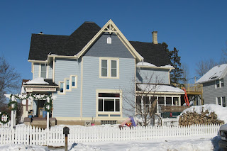 Home as repairs near completion (snow, sunny)