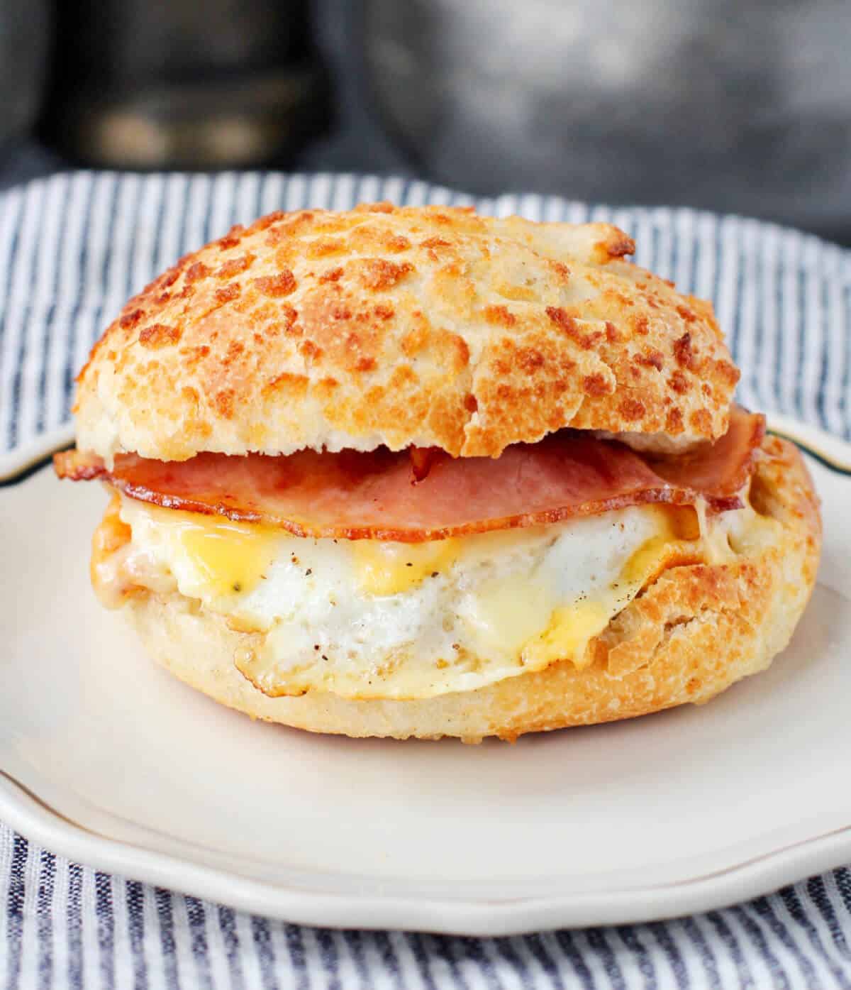 Tiger Bread Roll breakfast sandwich with egg, cheese, and ham.