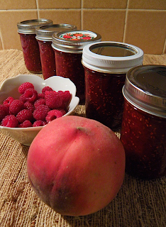 5 jars of jam with big peach and raspberries