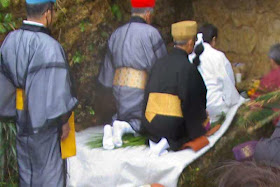 praying and making offerings at a well