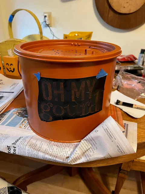 Photo of a Dollar Tree Stencil centered on the front of a minnow bucket.